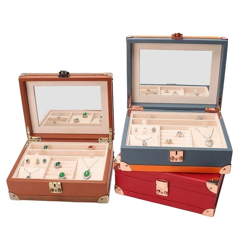 Wood and PU jewelry storage boxes with mirrors in the lids, holding rings and small pieces